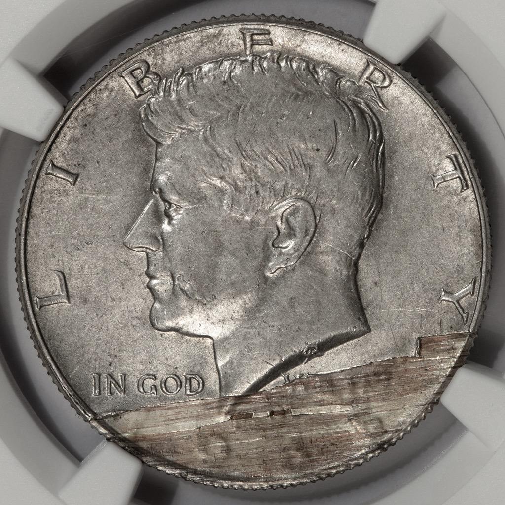 1965 Kennedy half dollar lamination error showing peeling and separation of the 40% silver clad layers